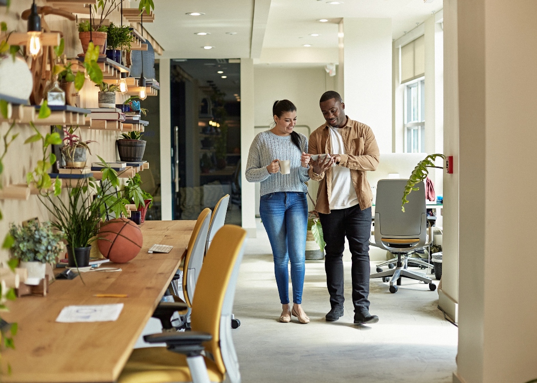 Colleagues in a walking meeting looking at an ipad