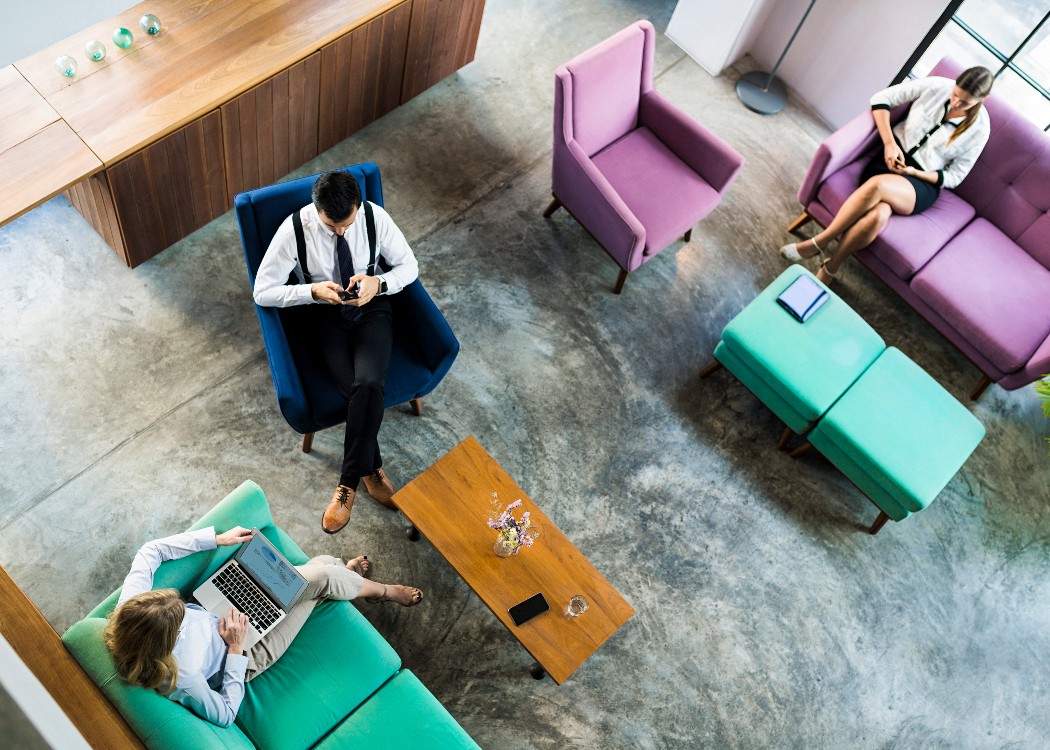 Team member sitting on coloured casual seating