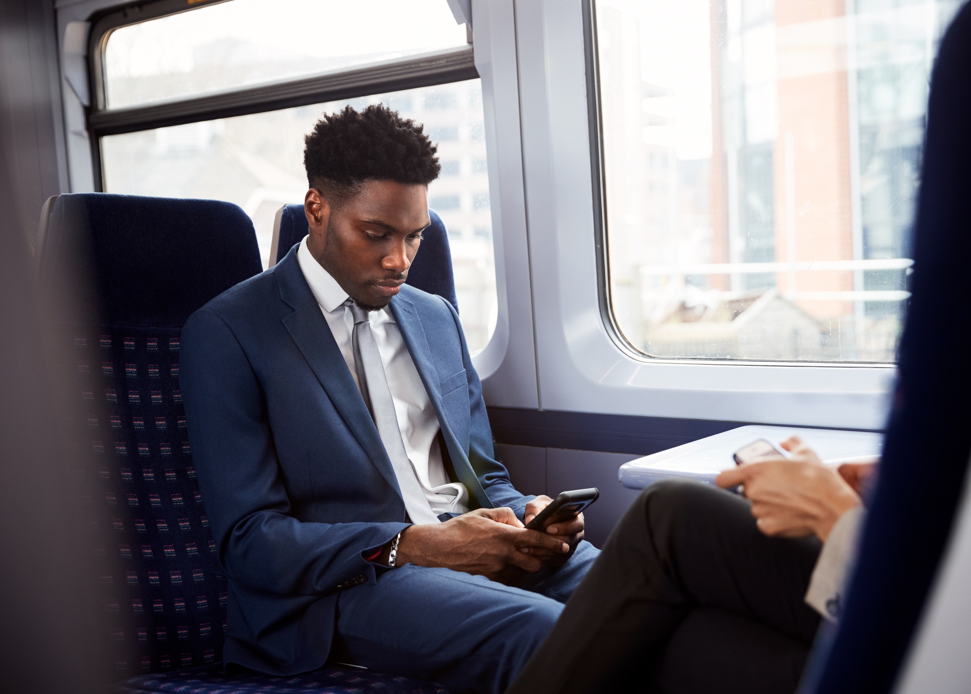 Man Commuting on His Phone